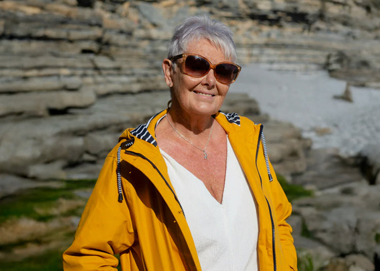 Zufriedene Seniorin an der Küste – authentische Rezension für mehr Lebensqualität
